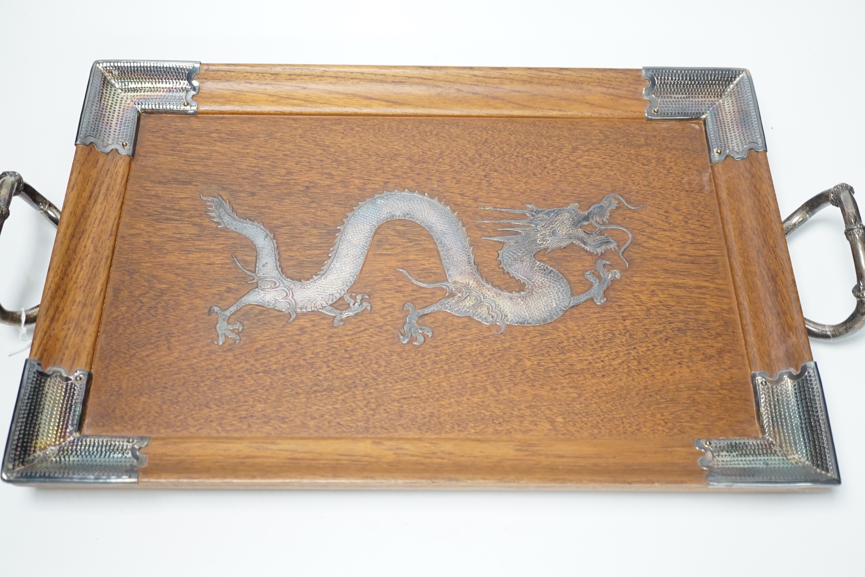 A Japanese white metal inlaid ‘dragon’ tray with bamboo style handles, 49cm wide